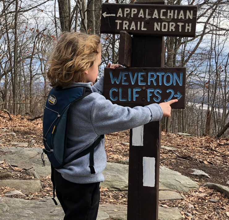 Child at Trail Sign