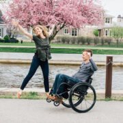 Young Couple Jumping, Man in Wheelchair, Woman on foot