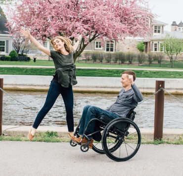 Young Couple Jumping, Man in Wheelchair, Woman on foot