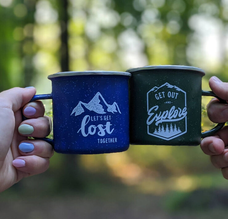 Two camping mugs cheersing