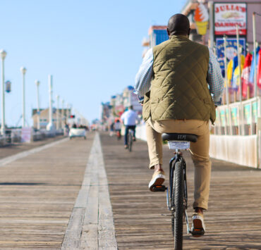 Man riding on a bike on the OCMD Boardwalk