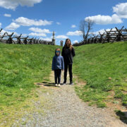 Two kids standing within the sunked road