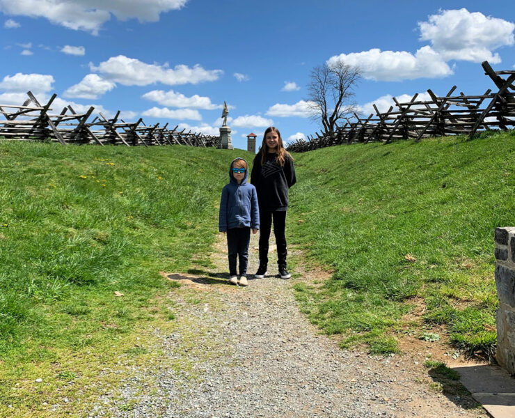 Two kids standing within the sunked road