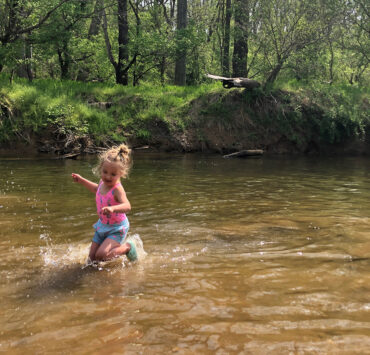 Child dancing in the water