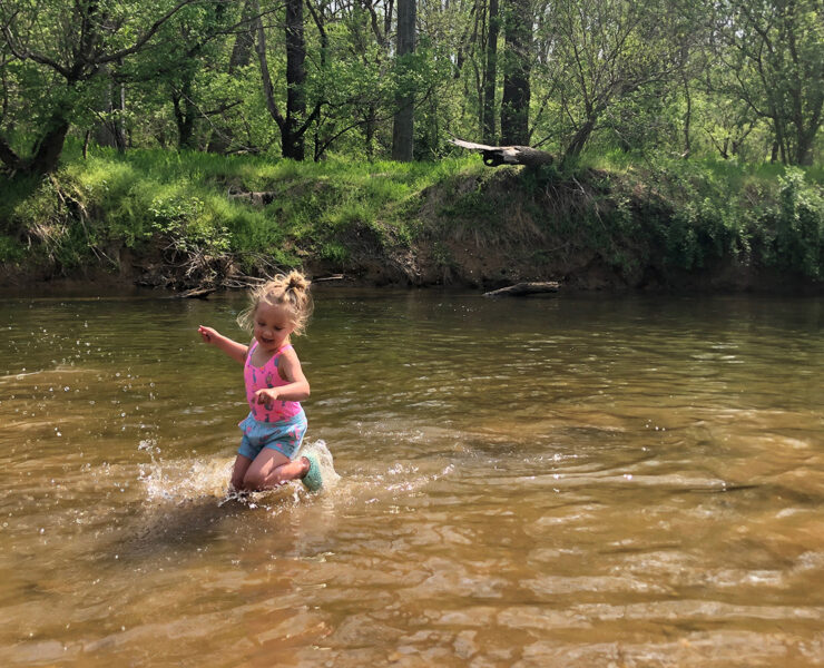 Child dancing in the water