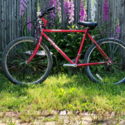 Red bike against a fence