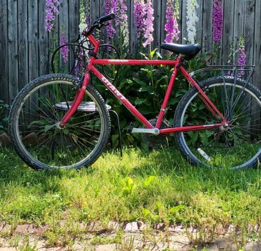 Red bike against a fence