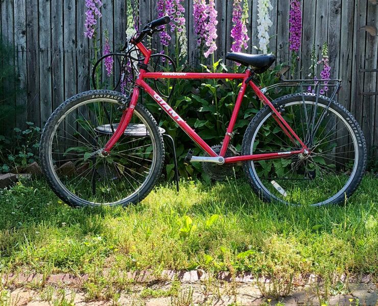 Red bike against a fence