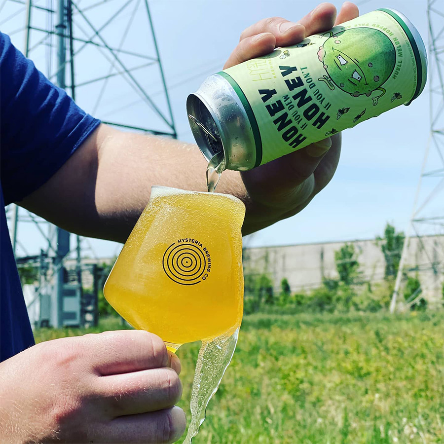 Hysteria Beer being poured out of the can into the glass