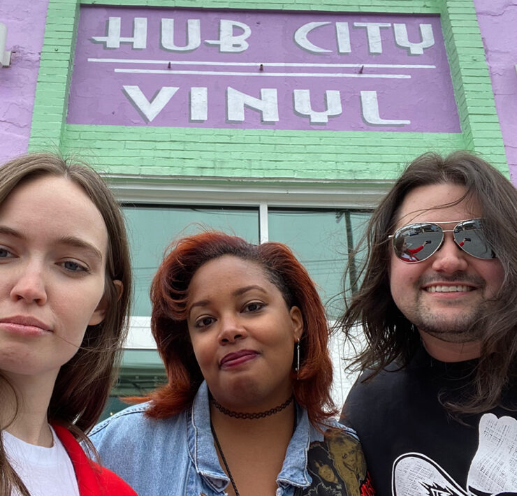 Three friends outside of Hub City Vinyl