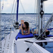 Man and woman laying on a boat that's on the water
