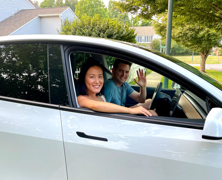 Two people sitting in a car looking out of the window