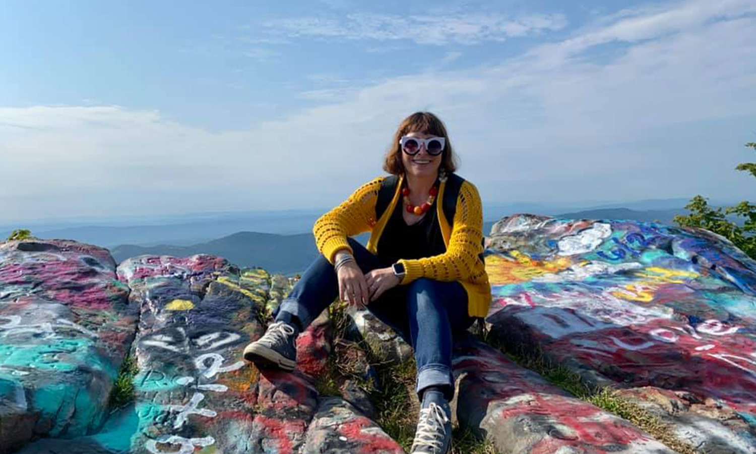 A woman sitting on a rock