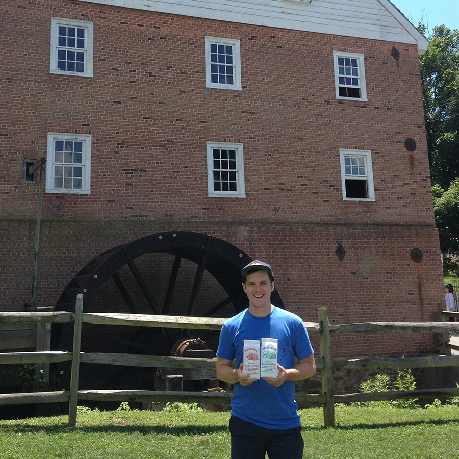 Man standing in front of Grist Mill