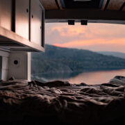 Looking out of a van onto the lake and a sunset