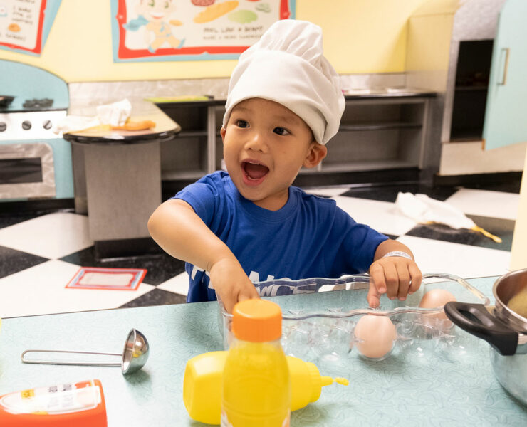 kid playing with toy food