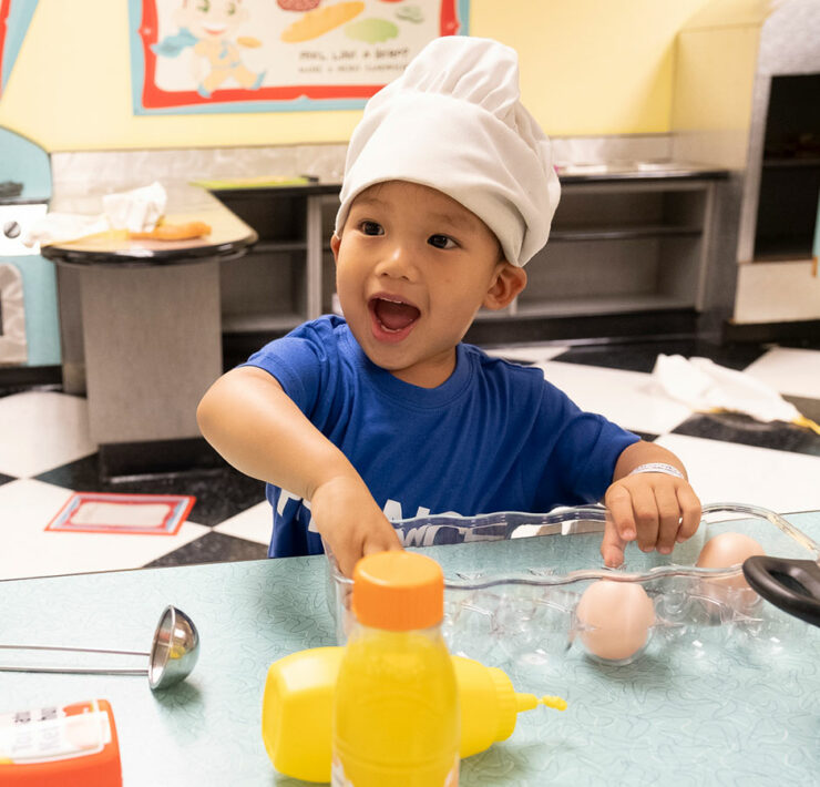 kid playing with toy food
