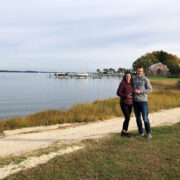 Couple with wine by the water
