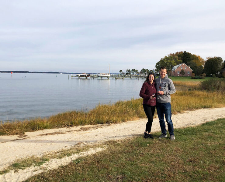 Couple with wine by the water