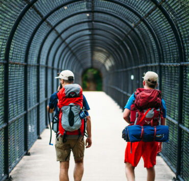 two men crossing the I-70 footbridge on the Appalachian Trail