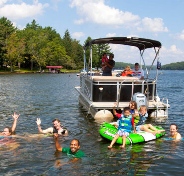 Family having fun on Deep Creek Lake with a boat