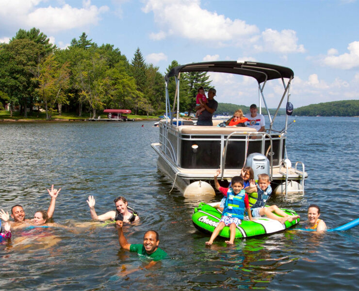 Family having fun on Deep Creek Lake with a boat