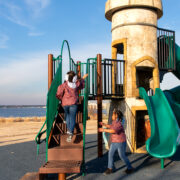 sisters on a playground by the water