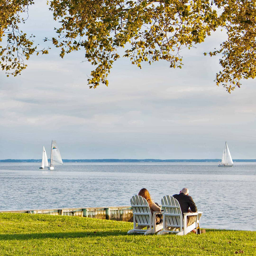 older couple enjoying the view of sailboats on the water
