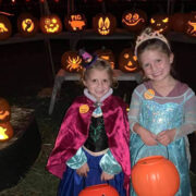 kids in halloween costumes with pumpkins