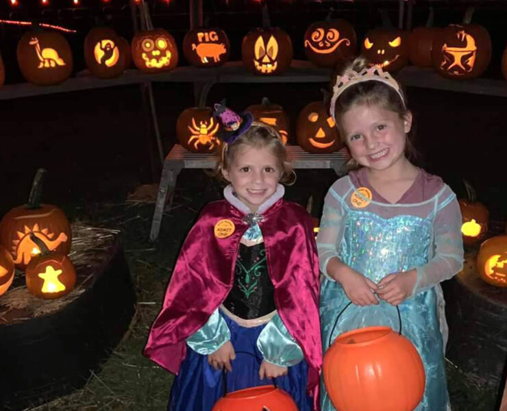 kids in halloween costumes with pumpkins