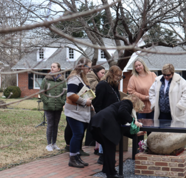 visitors looking at the rock