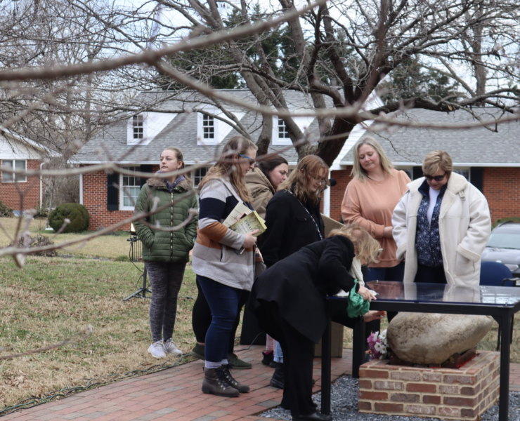 visitors looking at the rock