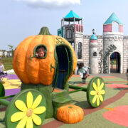 Cinderella-esque pumpkin at playground with little girl peeking her head out