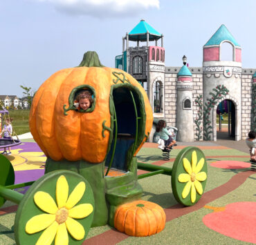 Cinderella-esque pumpkin at playground with little girl peeking her head out
