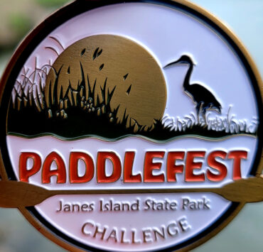 Paddlefest token/medal in writer's hand