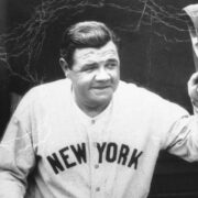 Babe Ruth in uniform tipping his cap to the fans