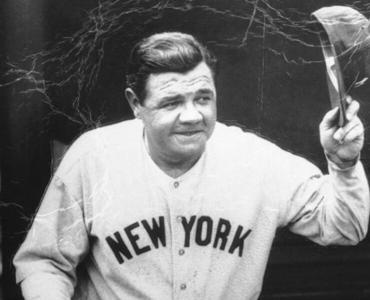 Babe Ruth in uniform tipping his cap to the fans