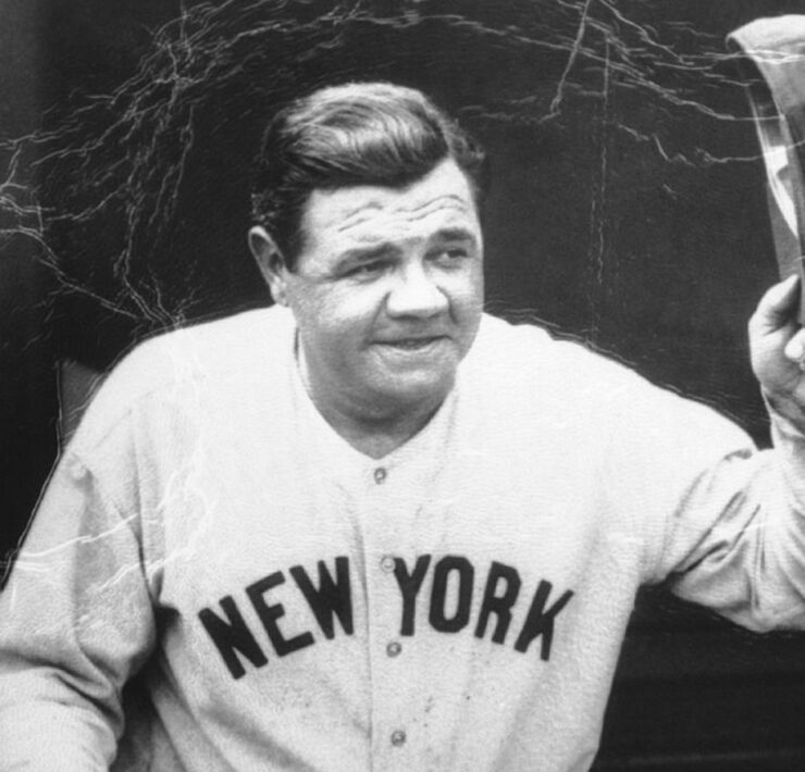 Babe Ruth in uniform tipping his cap to the fans