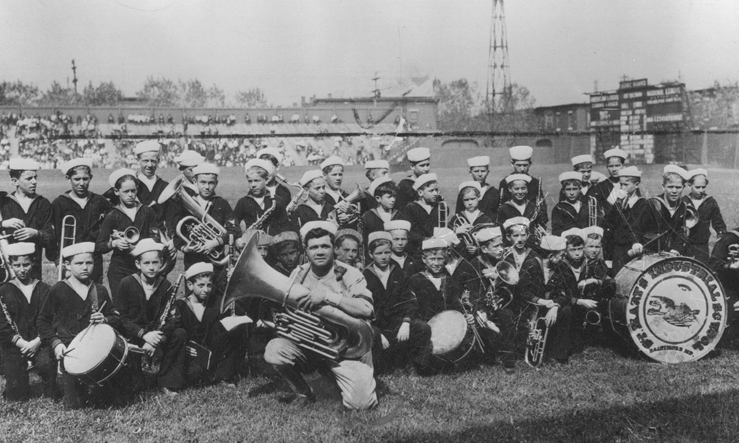 Ruth is pictured with the band from St. Mary's Industrial School on a field