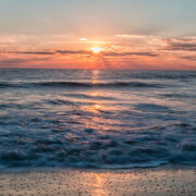 Sunrise on the water, waves crashing