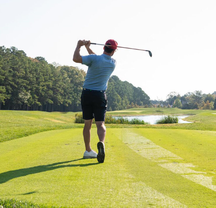 Person teeing off on a golf course