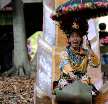 Festival goer sliding down a slide