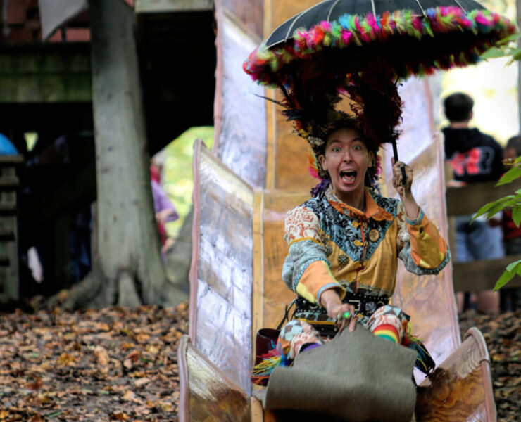 Festival goer sliding down a slide