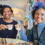 Two people toasting at a tea party