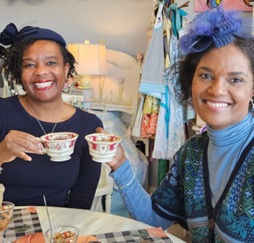 Two people toasting at a tea party