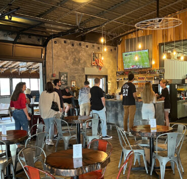 Interior of a brewery with a line to the bar
