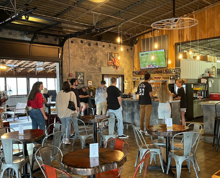 Interior of a brewery with a line to the bar