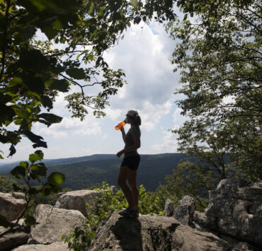 A hiker reaches the summit of Chimney Rock Trail in Catoctin Mountain Park