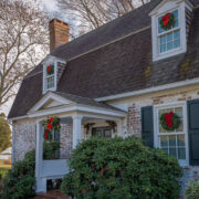 Outside of a historical home decorated with wreaths