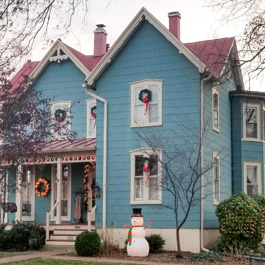 Outside of a historical home decorated with wreaths